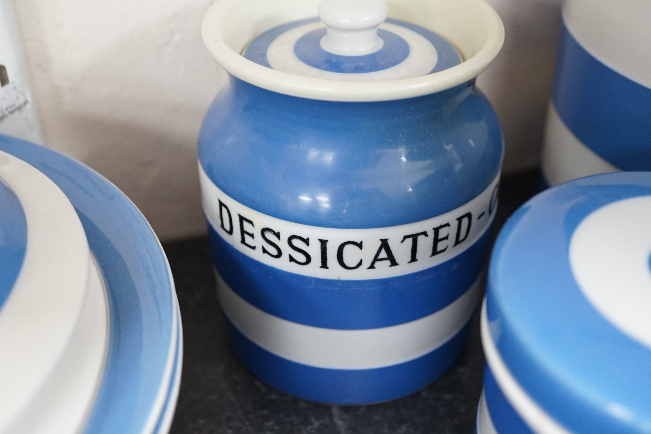 T.G.Green Cornish Kitchenware, fifteen lidded storage jars to include Meal, Granulated Sugar, Dessicated-Coconut and Sea Salt, largest 20cm high, mainly Black Shield marks. Condition - poor, fair and good
